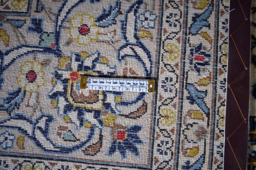 Corner detail of 2000s Kashan rug showing border pattern and Wool pile