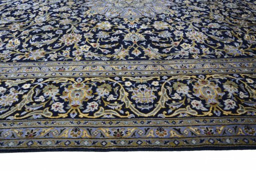 Corner detail of 2000s Kashan rug showing border pattern and Wool pile