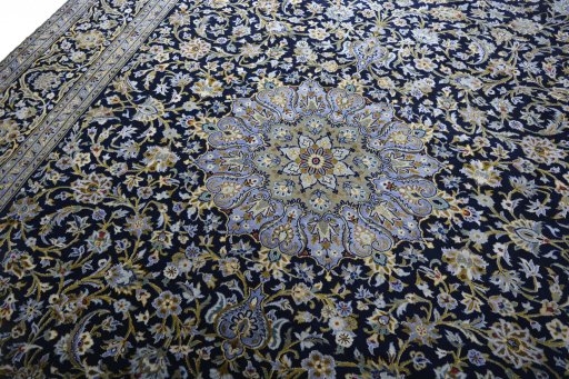 Backside of handmade 2000s Kashan rug showing knot structure and weave density