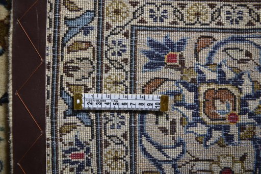 Corner detail of 2000s Kashan rug showing border pattern and Wool pile