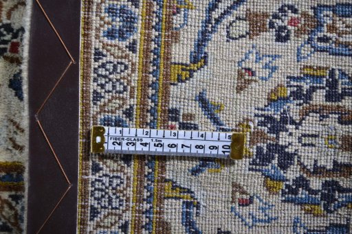 Corner detail of 2000s Kashan rug showing border pattern and Wool pile