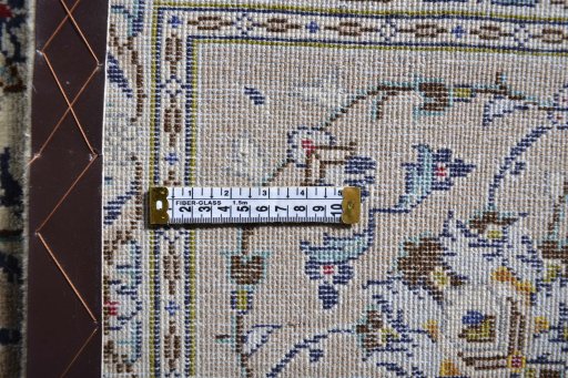 Corner detail of 2000s Kashan rug showing border pattern and Wool pile