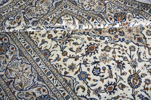 Corner detail of 2000s Kashan rug showing border pattern and Wool pile