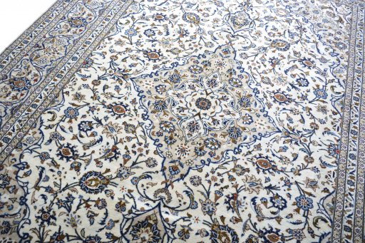 Backside of handmade 2000s Kashan rug showing knot structure and weave density