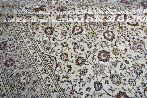 Corner detail of 2000s Kashan rug showing border pattern and Wool pile
