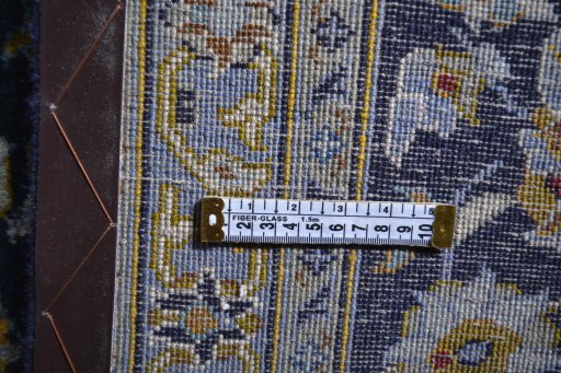 Corner detail of 2000s Kashan rug showing border pattern and Wool pile