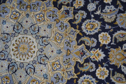 Backside of handmade 2000s Kashan rug showing knot structure and weave density