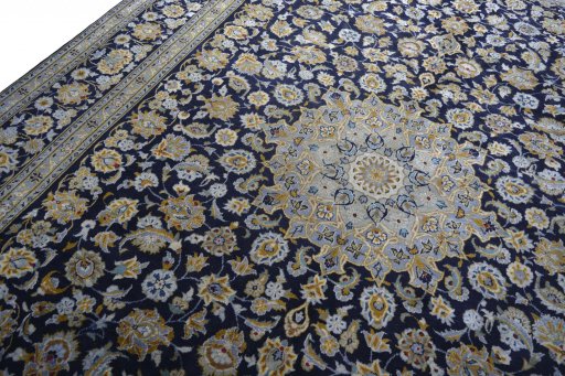 Backside of handmade 2000s Kashan rug showing knot structure and weave density