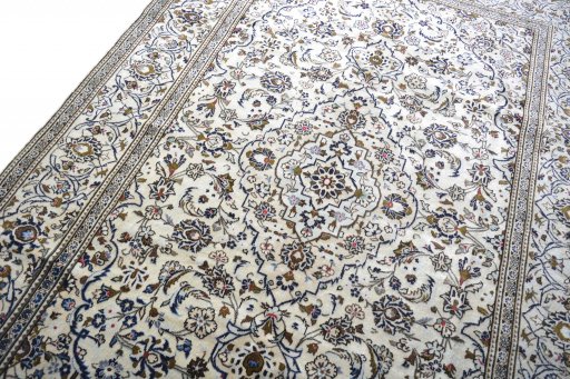 Backside of handmade 2000s Kashan rug showing knot structure and weave density