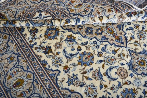 Corner detail of 2000s Kashan rug showing border pattern and Wool pile