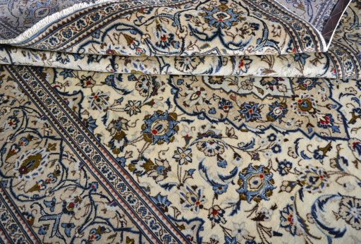 Corner detail of 2000s Kashan rug showing border pattern and Wool pile