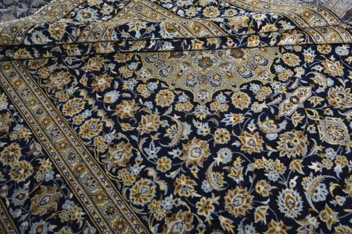 Corner detail of 2000s Kashan rug showing border pattern and Wool pile