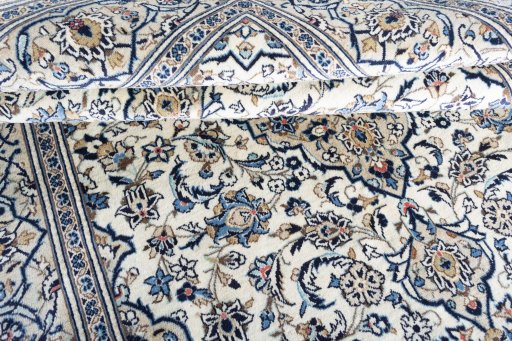 Corner detail of 2000s Kashan rug showing border pattern and Wool pile
