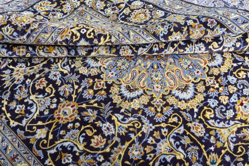 Close-up detail of 2000s Kashan rug from Iran / Persia showing Wool weave
