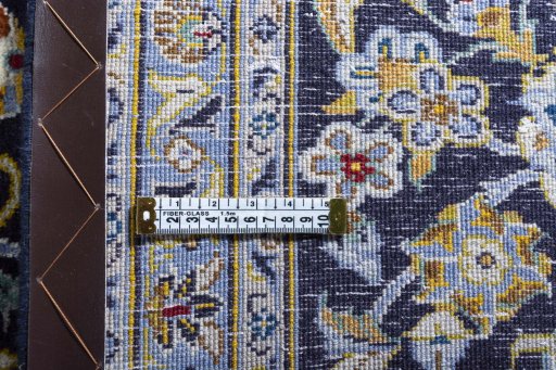 Backside of handmade 2000s Kashan rug showing knot structure and weave density