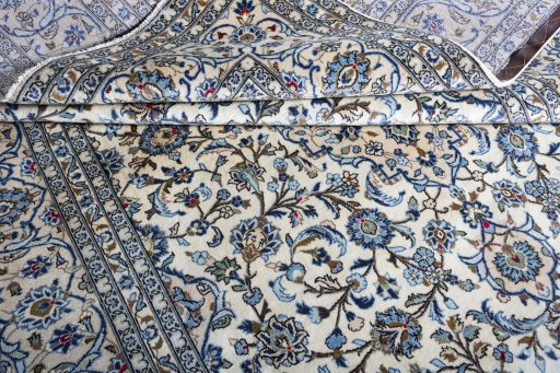 Corner detail of 2000s Kashan rug showing border pattern and Wool pile
