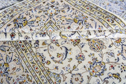 Corner detail of 2000s Kashan rug showing border pattern and Wool pile