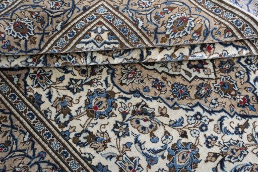Corner detail of 2000s Kashan rug showing border pattern and Wool pile