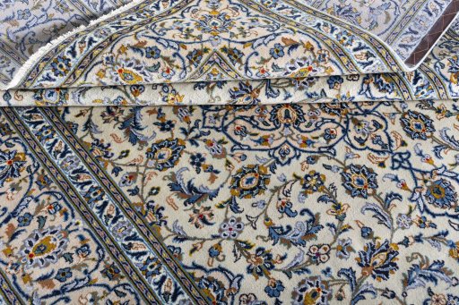 Corner detail of 2000s Kashan rug showing border pattern and Wool pile