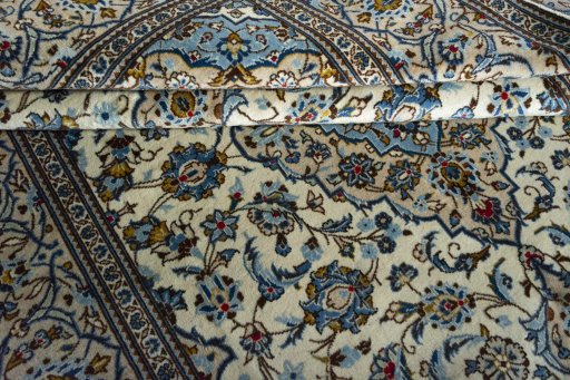 Corner detail of 2000s Kashan rug showing border pattern and Wool pile