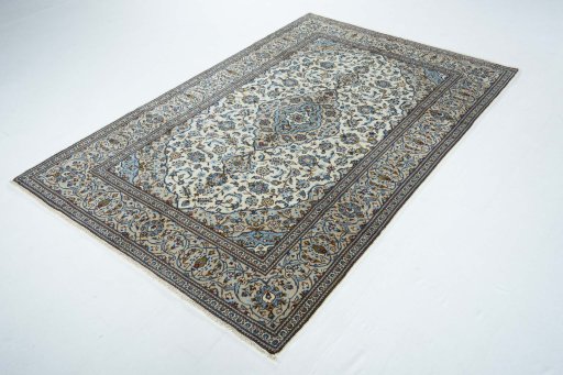 Corner detail of 2000s Kashan rug showing border pattern and Wool pile