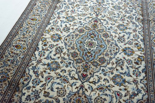 Backside of handmade 2000s Kashan rug showing knot structure and weave density