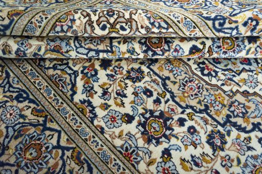 Corner detail of 2000s Kashan rug showing border pattern and Wool pile