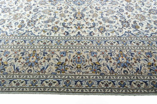 Corner detail of 2000s Kashan rug showing border pattern and Wool pile
