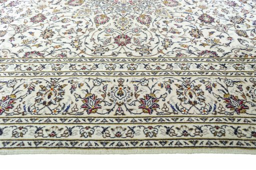 Corner detail of 2000s Kashan rug showing border pattern and Wool pile