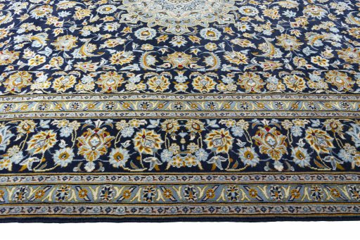 Corner detail of 2000s Kashan rug showing border pattern and Wool pile