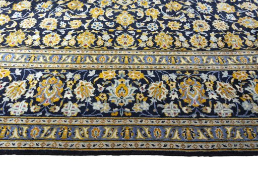 Corner detail of 2000s Kashan rug showing border pattern and Wool pile