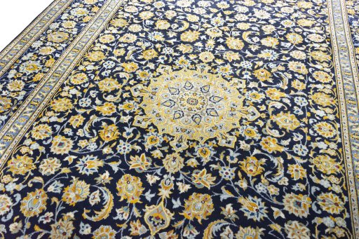 Backside of handmade 2000s Kashan rug showing knot structure and weave density