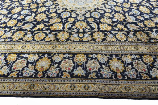 Corner detail of 2000s Kashan rug showing border pattern and Wool pile