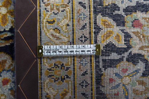 Backside of handmade 2000s Kashan rug showing knot structure and weave density