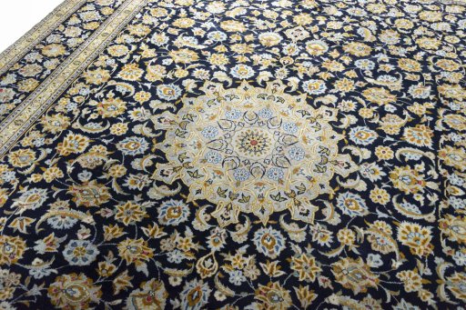 Backside of handmade 2000s Kashan rug showing knot structure and weave density
