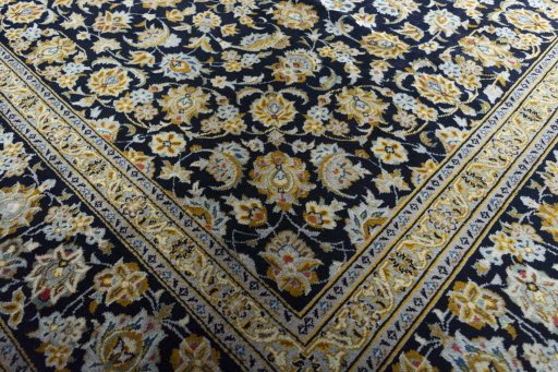 Close-up detail of 2000s Kashan rug from Iran / Persia showing Wool weave
