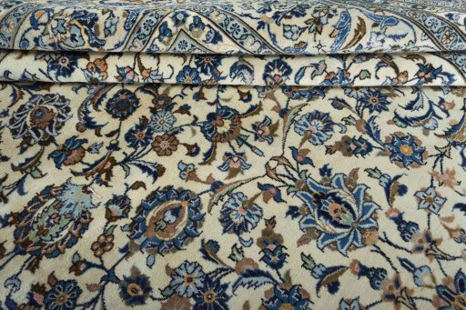 Corner detail of 2000s Kashan rug showing border pattern and Wool pile