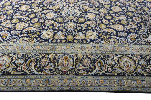 Corner detail of 2000s Kashan rug showing border pattern and Wool pile