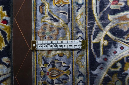Backside of handmade 2000s Kashan rug showing knot structure and weave density