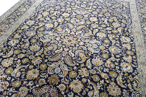 Backside of handmade 2000s Kashan rug showing knot structure and weave density