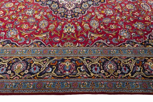 Corner detail of 2000s Kashan rug showing border pattern and Wool pile