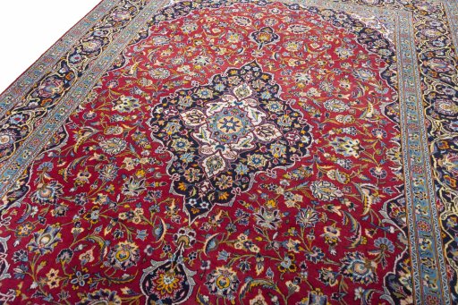 Backside of handmade 2000s Kashan rug showing knot structure and weave density