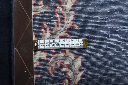 Corner detail of 2000s Kashan rug showing border pattern and Wool pile