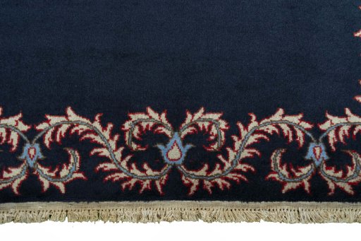 Backside of handmade 2000s Kashan rug showing knot structure and weave density