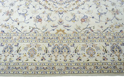 Corner detail of 2000s Kashan rug showing border pattern and Wool pile
