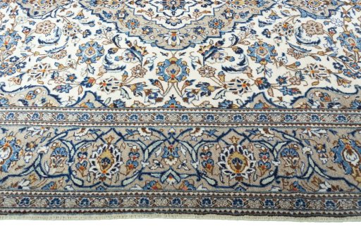 Corner detail of 2000s Kashan rug showing border pattern and Wool pile