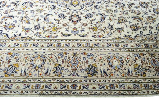 Corner detail of 2000s Kashan rug showing border pattern and Wool pile