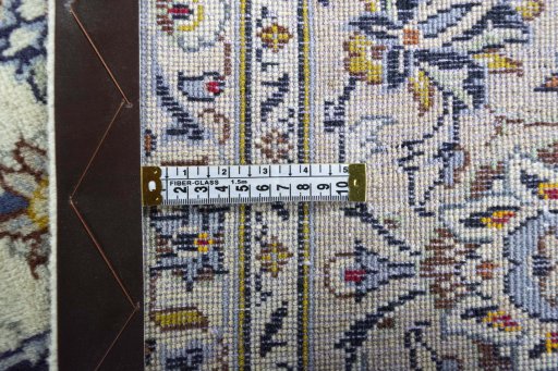 Backside of handmade 2000s Kashan rug showing knot structure and weave density