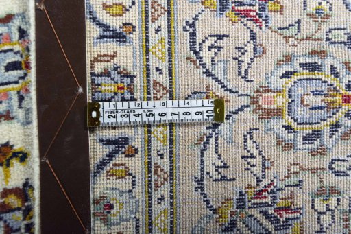 Backside of handmade 2000s Kashan rug showing knot structure and weave density