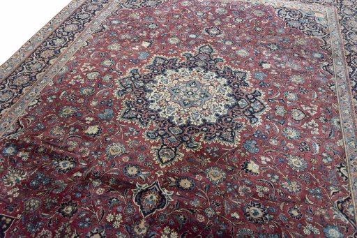 Backside of handmade 1930s Kashan rug showing knot structure and weave density